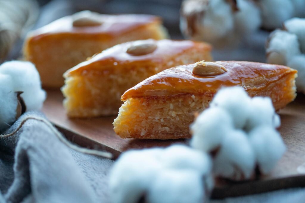 Delicious ?oroccqn basbousa slices topped with almonds, perfect for dessert lovers.