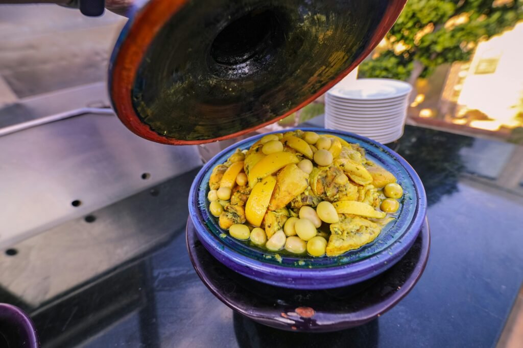 pexels-photo-2287524-2287524 Traditional Moroccan tagine with lemons and olives, served outdoors, showcasing vibrant colors and delicious aromas.