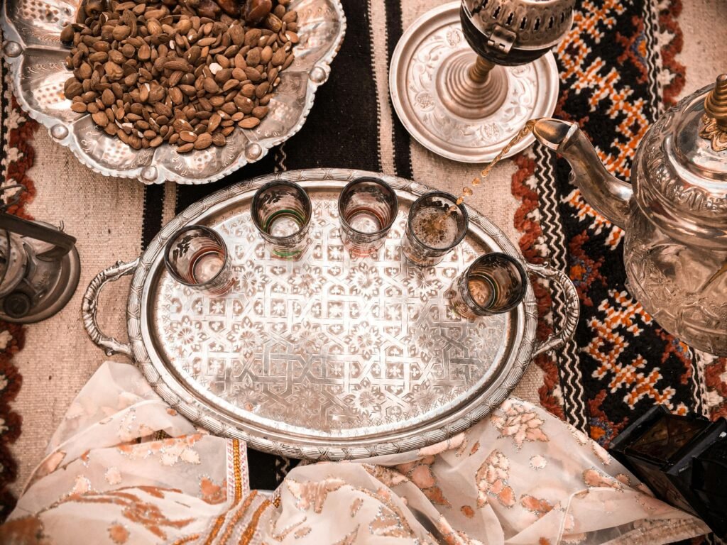 Elegant Moroccan tea setup on a decorative tray with almonds in Marrakesh, Morocco.