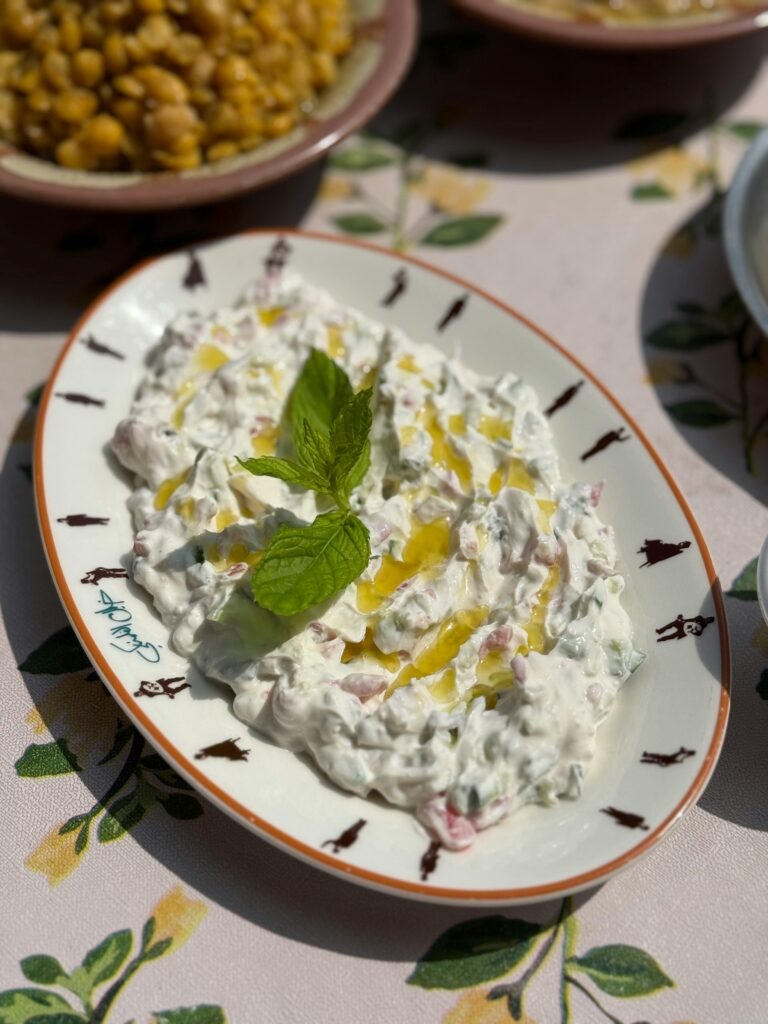 Delicious creamy tzatziki garnished with fresh mint and olive oil, perfect for a summer meal.