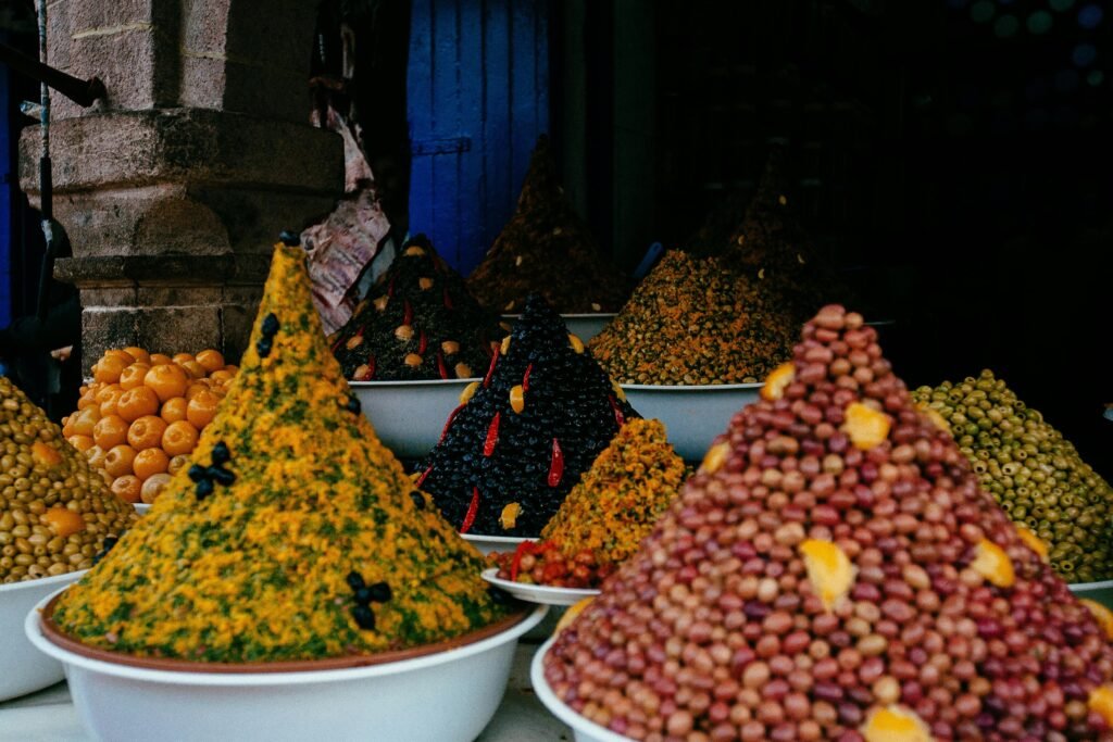 Vibrant array of spices and condiments on display in Essaouira market, Morocco.
